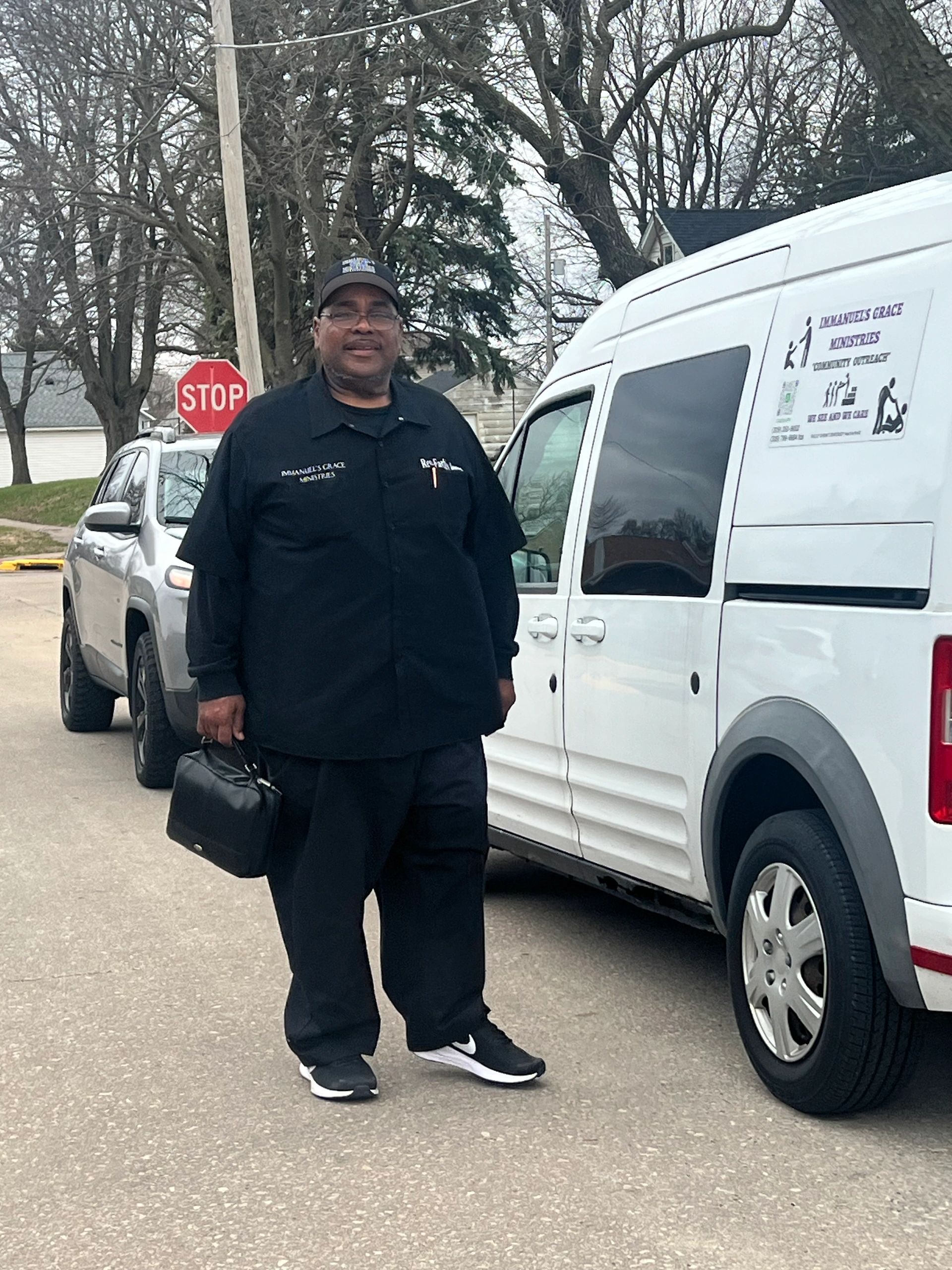 Immanuel's Grace Ministries outreach leader standing beside the ministry van