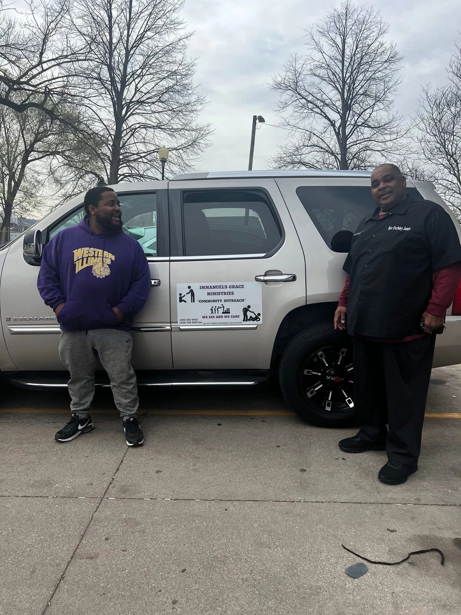 Outreach team members standing beside an Immanuel's Grace Ministries van